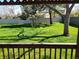 Picture perfect backyard featuring green grass, established trees, and a privacy fence at 2619 S Iris Ct, Lakewood, CO 80227
