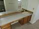 Bright bathroom with vanity featuring granite countertop, cabinetry, and large mirror at 2619 S Iris Ct, Lakewood, CO 80227