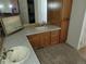 Bathroom featuring dual sinks, spacious countertop and oak cabinetry at 2619 S Iris Ct, Lakewood, CO 80227