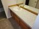 Bathroom vanity featuring ample counter space and storage in the brown cabinetry at 2619 S Iris Ct, Lakewood, CO 80227