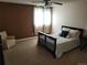 A cozy bedroom features a ceiling fan, bright window, neutral carpet, and an armchair at 2619 S Iris Ct, Lakewood, CO 80227
