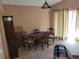 Traditional dining room featuring a wooden table with seating for four, soft carpet, and bright light at 2619 S Iris Ct, Lakewood, CO 80227
