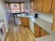 Bright kitchen featuring wooden cabinets, granite countertops, stainless steel appliances, and a breakfast nook dining area at 2619 S Iris Ct, Lakewood, CO 80227