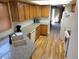 Well-lit kitchen featuring light wood cabinets, granite countertops, white appliances, and wood flooring, perfect for cooking at 2619 S Iris Ct, Lakewood, CO 80227