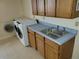 Well-equipped laundry room with modern washer and dryer, cabinets, and ample counter space for easy chores at 2619 S Iris Ct, Lakewood, CO 80227