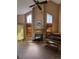 Bright living room with a fireplace, piano, and large windows, ideal for cozy gatherings and showcasing a musical talent at 2619 S Iris Ct, Lakewood, CO 80227