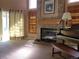 Bright living room with a fireplace, piano, and natural light, creating an inviting space for relaxation at 2619 S Iris Ct, Lakewood, CO 80227