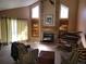Inviting living room with vaulted ceilings, large windows, fireplace, piano, and comfortable seating for relaxation at 2619 S Iris Ct, Lakewood, CO 80227