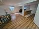 Open-concept living room with hardwood flooring, sofa, and bar, offering space for relaxation and entertainment at 2619 S Iris Ct, Lakewood, CO 80227