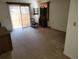 Spacious living room with neutral carpet, slider door access to patio and vintage furnishings at 2619 S Iris Ct, Lakewood, CO 80227