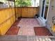 Enclosed patio with brick pavers, wood fencing, and wood chip ground covering at 2619 S Iris Ct, Lakewood, CO 80227