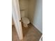 Toilet room with light beige walls, neutral flooring, and a standard toilet at 2619 S Iris Ct, Lakewood, CO 80227