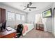 Bedroom with neutral paint, carpeted floors, a ceiling fan and a view of the window at 132 Mesa St, Brighton, CO 80601