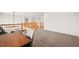 Second floor hallway with wood railing and carpet offers lots of bright light at 132 Mesa St, Brighton, CO 80601