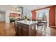 Modern kitchen island adjacent to a dining area in a home with lots of natural light and open concept living at 132 Mesa St, Brighton, CO 80601