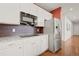 Bright kitchen with stainless steel refrigerator and a modern electric cooktop offers a contemporary cooking experience at 132 Mesa St, Brighton, CO 80601