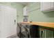 Well-lit laundry room with modern front load washer and dryer and plenty of cabinet space at 132 Mesa St, Brighton, CO 80601