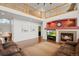 Spacious living room with fireplace, clerestory windows, and open access to the dining room at 132 Mesa St, Brighton, CO 80601