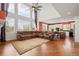 Open-concept living room with soaring ceilings, large windows, and eat-in kitchen offers ample space for Gathering gatherings at 132 Mesa St, Brighton, CO 80601