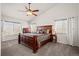 Bright main bedroom with vaulted ceilings, large windows, and a wood furniture set at 132 Mesa St, Brighton, CO 80601
