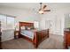 Spacious main bedroom featuring wood furniture, a ceiling fan, and access to the walk-in closet at 132 Mesa St, Brighton, CO 80601
