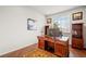 Bright home office features a large desk with wood flooring and natural light at 132 Mesa St, Brighton, CO 80601