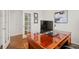Home office with french doors and hardwood floors has large executive desk at 132 Mesa St, Brighton, CO 80601