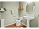 Cozy powder room with a pedestal sink, decorative towel rack, and a modern toilet at 132 Mesa St, Brighton, CO 80601