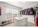 Walk-in closet with a window, shelving and granite-topped center island at 132 Mesa St, Brighton, CO 80601