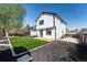 Well-maintained backyard with artificial turf, patio, mulch beds, stone accents, and a two-story home at 12018 Hudson Ct, Thornton, CO 80241