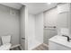 Modern bathroom featuring a sleek white vanity and walk-in shower with white tiling and light gray walls at 12018 Hudson Ct, Thornton, CO 80241