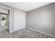 Neutral bedroom with gray walls, carpet, white trim, and a closet with double sliding doors at 12018 Hudson Ct, Thornton, CO 80241