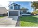 Charming two-story home featuring a modern two-car garage and a welcoming front porch at 12018 Hudson Ct, Thornton, CO 80241