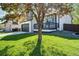 View of a well-maintained two story home with front lawn and landscaping at 12018 Hudson Ct, Thornton, CO 80241
