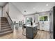 Modern kitchen with stainless steel appliances, center island, and stairs nearby at 12018 Hudson Ct, Thornton, CO 80241