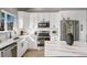 Bright kitchen featuring white cabinets, stainless steel appliances, and marble countertops at 12018 Hudson Ct, Thornton, CO 80241
