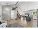 Open floor plan with kitchen island, staircase, and view to sitting area at 12018 Hudson Ct, Thornton, CO 80241