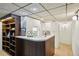 Basement bar with wood accents, open shelving, a sink, and white cabinets for storage at 1118 Eagle Rd, Broomfield, CO 80020