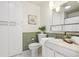 Cozy bathroom featuring white cabinets, neutral-toned tile, and plants at 1118 Eagle Rd, Broomfield, CO 80020