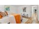 Bright bedroom featuring hardwood floors, contemporary decor, and a view to the outdoor sunroom through a window at 1118 Eagle Rd, Broomfield, CO 80020