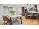 Dining room with hardwood floors, modern lighting, and opens to kitchen with bar seating at 1118 Eagle Rd, Broomfield, CO 80020