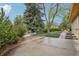 Long driveway leading to a home surrounded by mature trees and colorful foliage at 1118 Eagle Rd, Broomfield, CO 80020