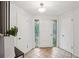 Bright foyer with tiled floors, leaded glass sidelights and white trim at 1118 Eagle Rd, Broomfield, CO 80020