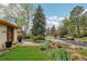 Inviting front yard with lush green grass, mature trees and meticulously maintained landscaping, plus street view at 1118 Eagle Rd, Broomfield, CO 80020