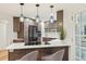 Modern kitchen with stainless steel appliances, quartz counters, stylish pendants, and sleek cabinets at 1118 Eagle Rd, Broomfield, CO 80020