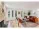 Bright living room features hardwood floors, brick fireplace, and large windows at 1118 Eagle Rd, Broomfield, CO 80020