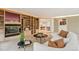 Open-concept living room featuring curved sofa, fireplace and built in bookshelf at 1118 Eagle Rd, Broomfield, CO 80020