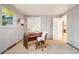Home office featuring a stylish wooden desk, fuzzy chair, and a window providing natural light at 1118 Eagle Rd, Broomfield, CO 80020