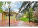 Spacious patio area with stone tiles, string lights, and mature trees, great for relaxing and entertaining outdoors at 1118 Eagle Rd, Broomfield, CO 80020