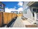 Well-maintained backyard featuring a gravel pathway, wood fence, and view of surrounding homes in the neighborhood at 700 Lillibrook Pl, Erie, CO 80026